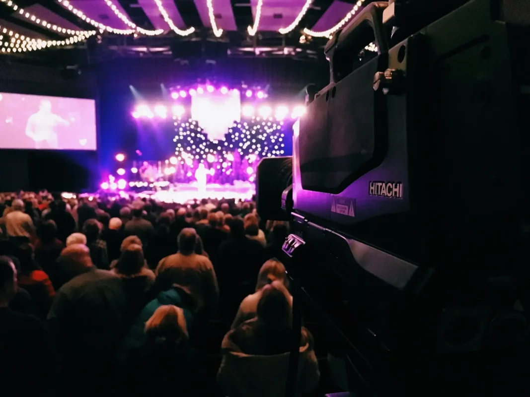 How to Choose a Projector for Church - An image of a church stage lit with purple lights and projectors.