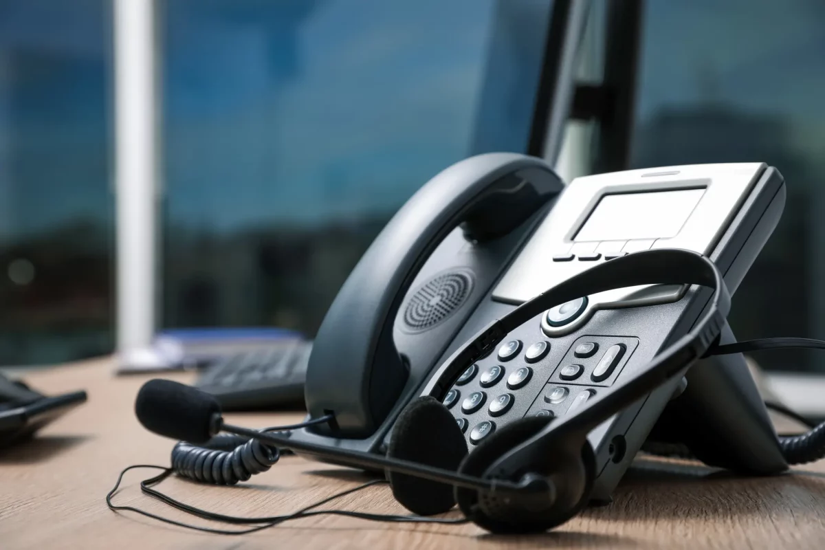 VOIP Baton Rouge. An image of a VOIP telephone on a desk with a headset sitting next to it.
